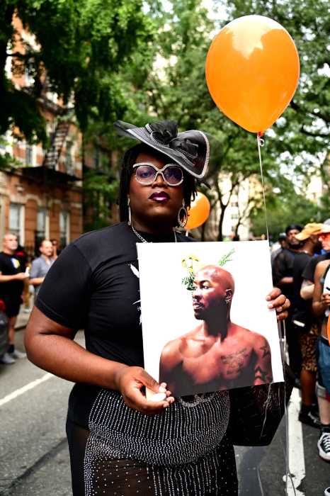 Qween Jean holds a picture of O'Shae Sibley.