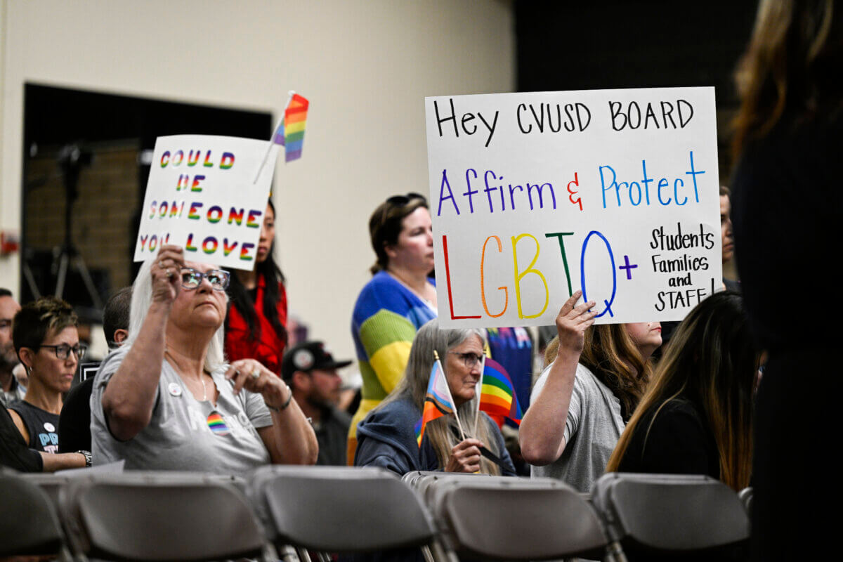 Parents, students, and staff of Chino Valley Unified School District hold up signs in favor of protecting LGBTQ+ policies at Don Antonio Lugo High School, on Thursday, June 15, 2023.