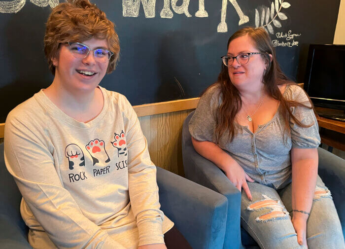 Nola Rhea, 17, left, and her mother, Heather Rhea, 47, sit together in a coffee shop on Sept. 26, 2023, in Lincoln, Neb., as they discuss Nola's plans to leave the state of Nebraska next year to attend college following the state's enactment of a law restricting gender-confirming medical treatments for minors.