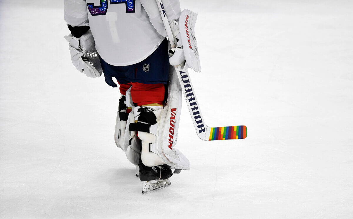 Florida Panthers goaltender Alex Lyon (34) warms up while celebrating Pride Night with a colorful hockey stick before playing the Toronto Maple Leafs, Thursday, March 23, 2023, in Sunrise, Fla.