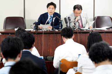 Lawyers of a claimant, Kazuyuki Minami, left, and Masafumi Yoshida, right, speak to media after the ruling of the Supreme Court Wednesday, Oct. 25, 2023, in Tokyo.