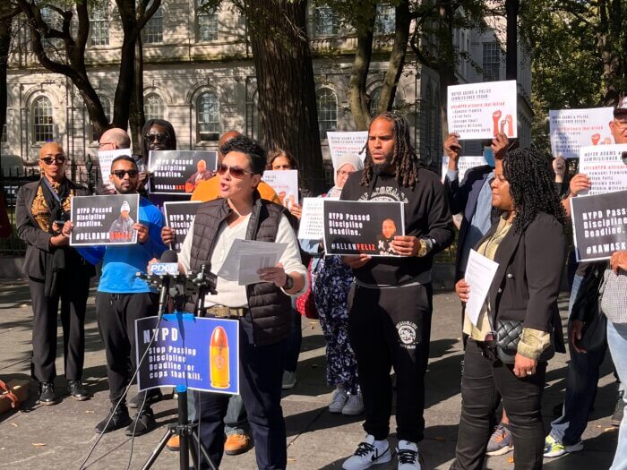 Loyda Colon, the executive director of the Justice Committee and member of Communities United for Police Reform, speaks alongside family members of individuals killed by police.