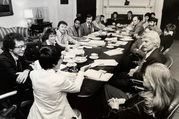 Attendees at the Task Force's 1977 meeting, clockwise from center: Midge Costanza, Robert Maulsom, Jean O'Leary, William Kelley, Achebe Betty Powell, Charles Brydon, Charlotte Spitzer, Myra Riddell, Cooki Lutkefedder, Ray Hartman, Pokey Anderson, George Raya, Frank Kameny, Reverend Troy Perry, Charlotte Bunch, Elaine Noble, Bruce Voeller, and Marilyn Haft.