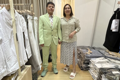 Naphat Krutthai, a transgender man, left, and Rasithaya Jindasri, pose for a photo as Naphat tried on a suit while he was shopping for clothes in Bangkok, Thailand, Tuesday, Dec. 5, 2023.
