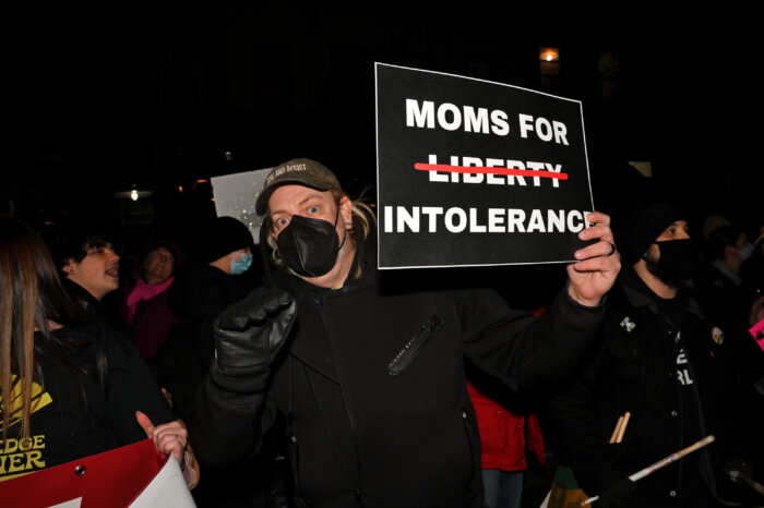 Many signs sought to reframe the name of the Moms for Liberty.