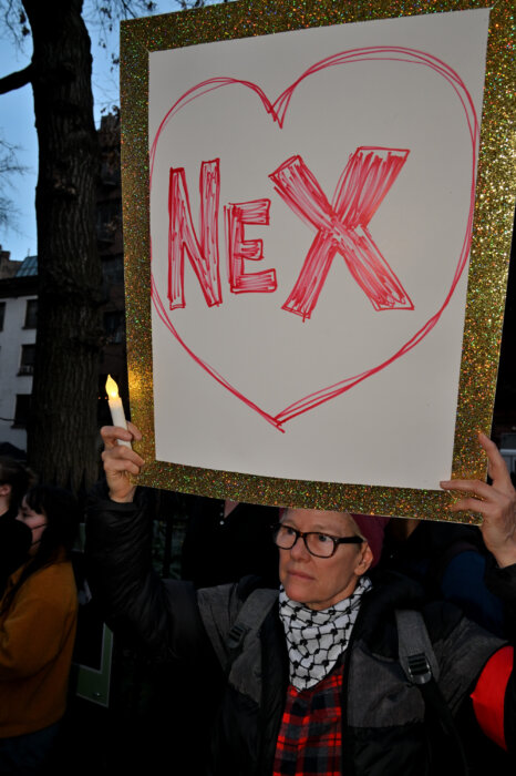 An activist at a vigal for Nex Benedict at the Stonewall Inn in February.