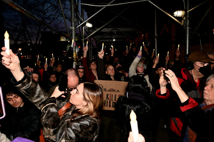 Attendees surround the Stonewall Inn during a vigil for Nex Benedict.