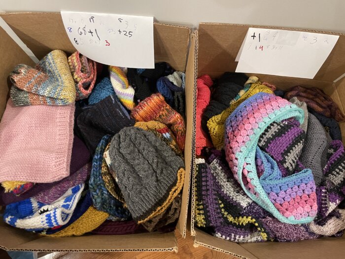 Handmade garments are sorted into two boxes.
