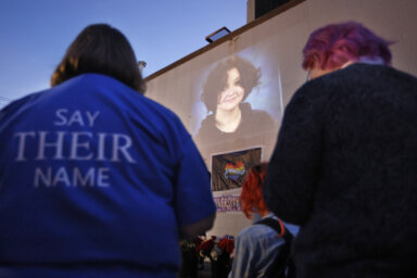A photograph of Nex Benedict, a non-binary teenager who died a day after a fight in a high school bathroom, is projected during a candlelight service at Point A Gallery, Saturday, Feb. 24, 2024, in Oklahoma City.