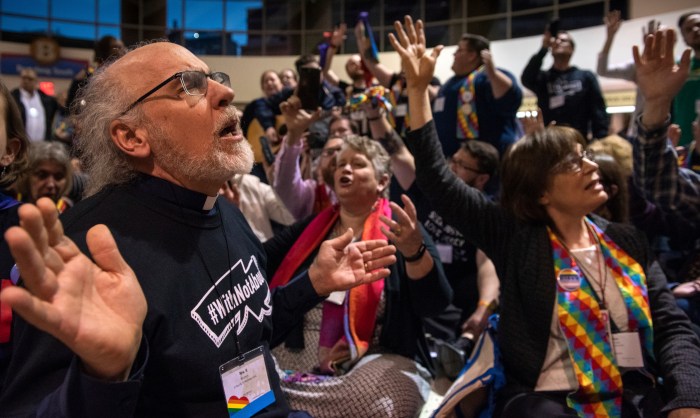 The Rev. K Karen, left, of St. Paul & St. Andrew United Methodist Church in New York joins other protesters in song and prayer outside the United Methodist Church's special session of the general conference in St. Louis, Tuesday, Feb. 26, 2019. Since 2019, the denomination has lost about one-fourth of its U.S. churches in breakup focused in large part on whether to accept same-sex marriage and ordination of LGBT clergy.