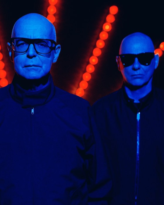 Pet Shop Boys stand in a dark room in a photo for their latest album artwork