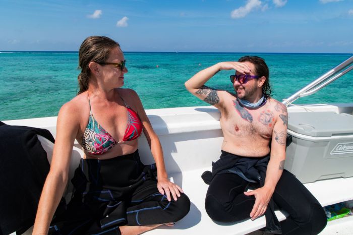 A Blue Note Scuba guest, left, talking with Niko Kowell, right, founder and owner of Narwhal Divers, on the dive boat in Cozumel, Mexico.