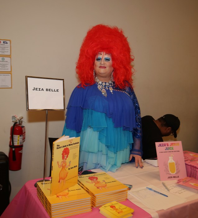 Drag persona Jeza Belle shows off books at the Rainbow Book Fair.