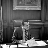 Harvey Milk sits at Mayor George Moscone's desk in 1978.