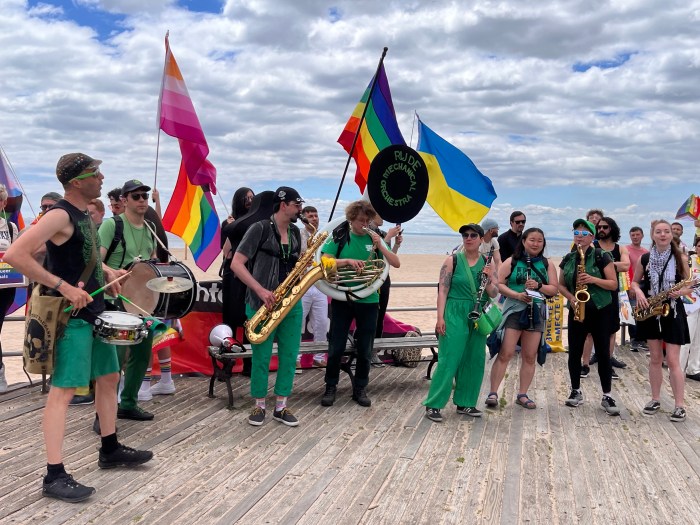 The Rude Mechanical Orchestra performs during the rally on the boardwalk in Brighton Beach.