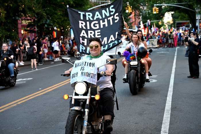 Dykes on Bike, with messages of support for trans rights and abortion rights, roar along Fifth Avenue in 2024.