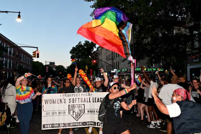 The Prospect Park Women's Softball League marches along Fifth Avenue at Brooklyn Pride in 2024.
