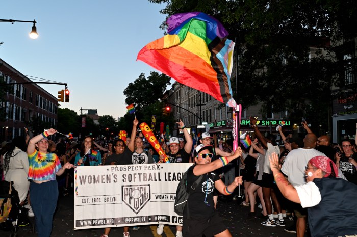 The Prospect Park Women's Softball League marches along Fifth Avenue at Brooklyn Pride.