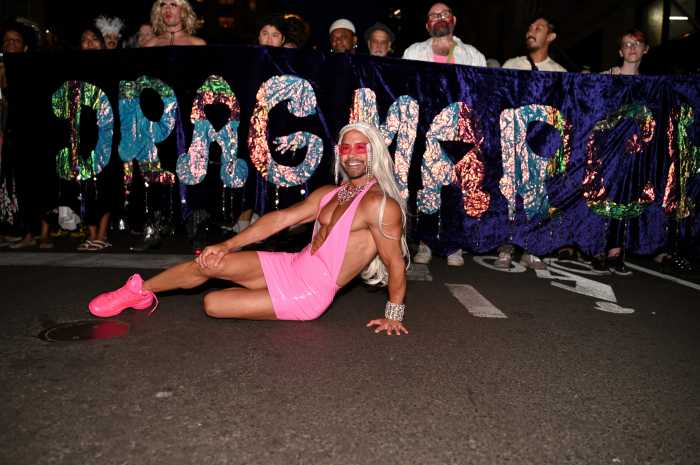 Posing with the 2024 Drag March banner.