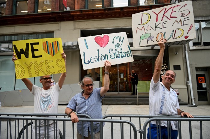 Spectators Daniel Wolfe and Richard Elovich (middle and right) are a mainstay on the sidelines of the Dyke March.