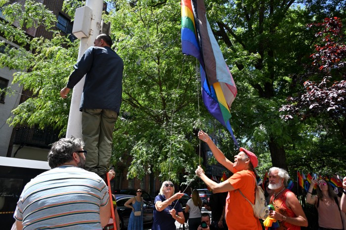 Advocates hoist the Rainbow Flag on the first day of Pride Month.