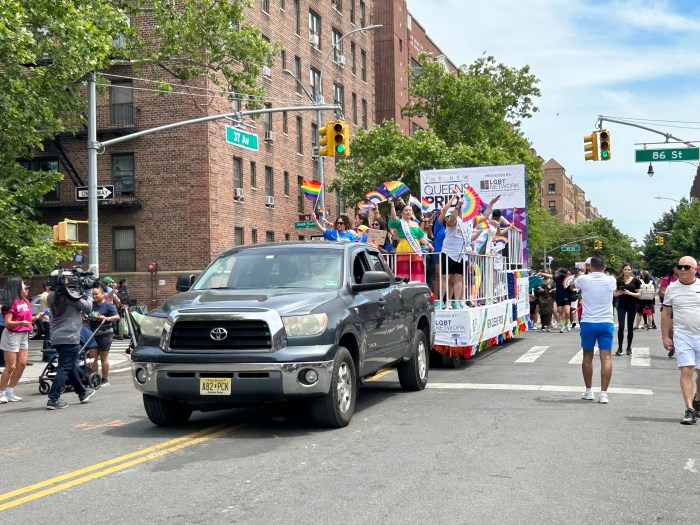 The Queens Pride contingent proceeds along the parade route.