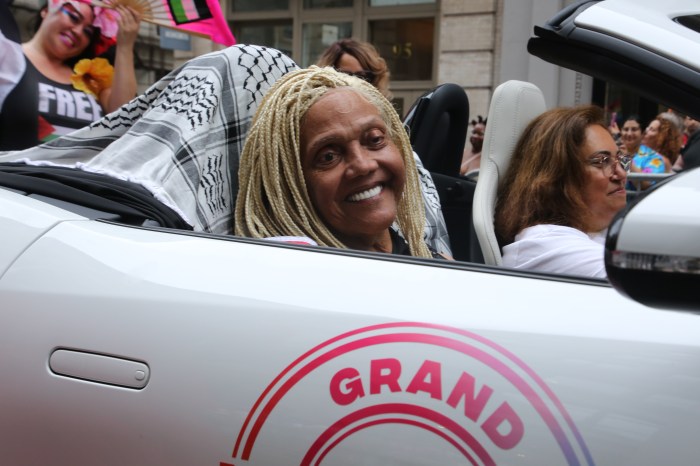 Grand Marshal Miss Major looks on.