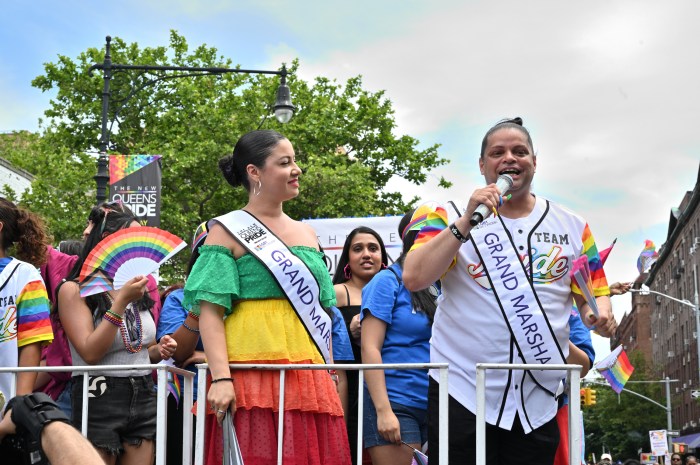 The grand marshals stand tall on the Queens Pride float.