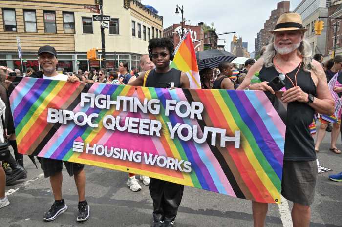 Charles King (right) carries Housing Works' banner at the 2024 Queer Liberation March.