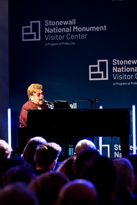 Equipped with his piano, Elton John closes out the event with a performance.