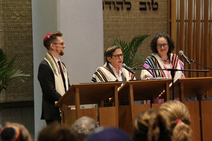 From L-R, Cantor Sam Rosen, Rabbi Sharon Kleinbaum and Rabbi Ayelet Cohen at the bema in the Congregation Beit Simchat Torah Synagogue on June 21, 2024.