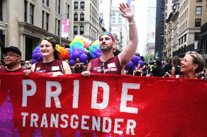 Heritage of Pride's banner leads the march.