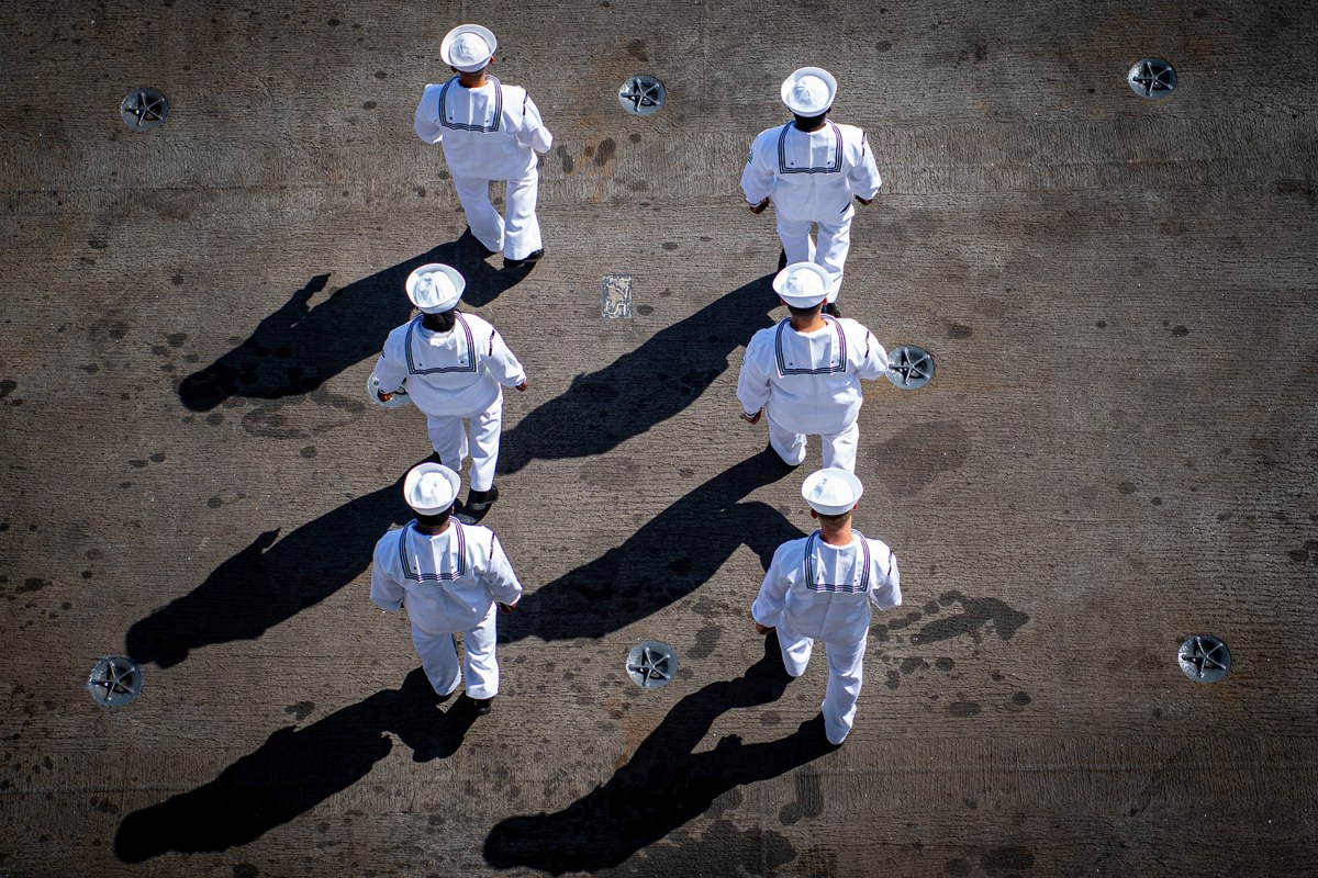 Sailors on the flight deck of the USS Nimitz at Naval Air Station in North Island, Calif., July 22, 2024.