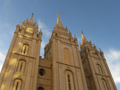 A picture of The Mormon Church from below during the day.