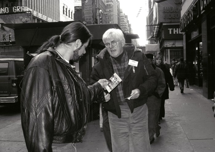 Phil Donahue passes out GMHC pamphlets on World AIDS Day in 1995.