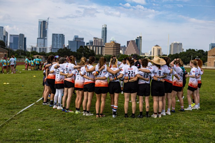 Team members gather on the grass during a scene in the film "Torched."