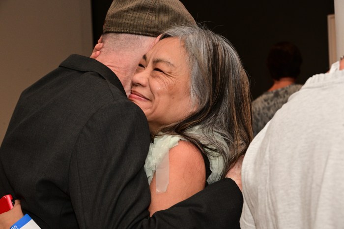 Ivy Arce, a longtime ACT UP New York member, greets Jim Eigo.