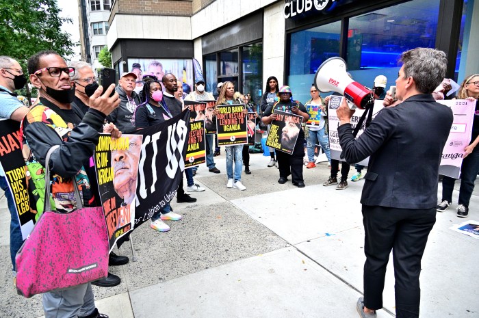 Advocates huddle outside of Uganda's Permanent Mission to the UN in Manhattan.