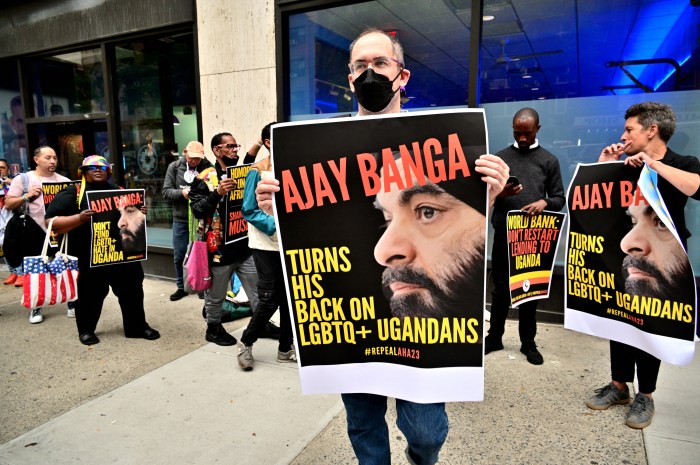 Signs denounce Ajay Banga, who serves as president of the World Bank.