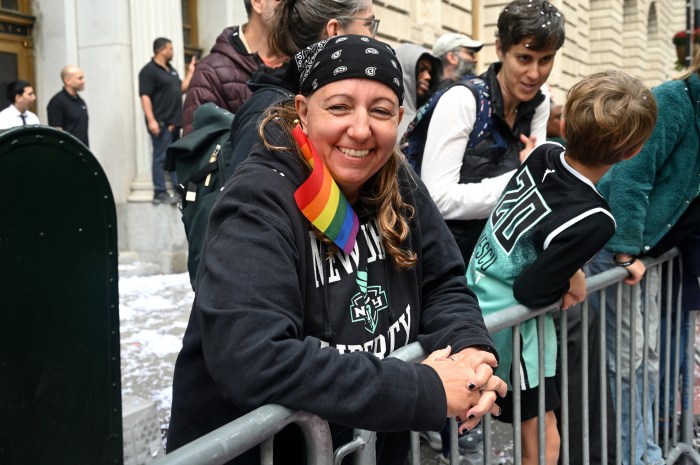 Fans wait for the champions to roll through the parade route.