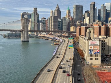 NYC skyline view and FDR Drive on a sunny day in Manhattan.