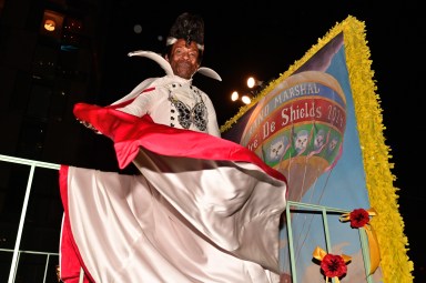 Grand marshal André De Shields shows his costume.