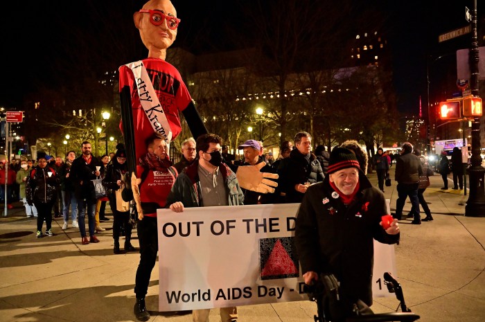 Brent Nicholson Earle leads the 2022 Out of the Darkness march against the backdrop of a towering tribute to the late HIV/AIDS activist Larry Kramer.