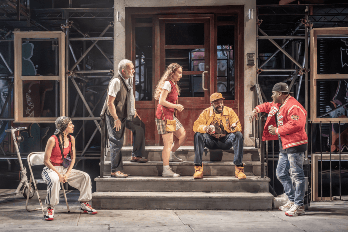 A scene from "THE PURISTS" involving Jasper Britton, Richard Pepple and Sule Rimi as they sit on stoop steps.