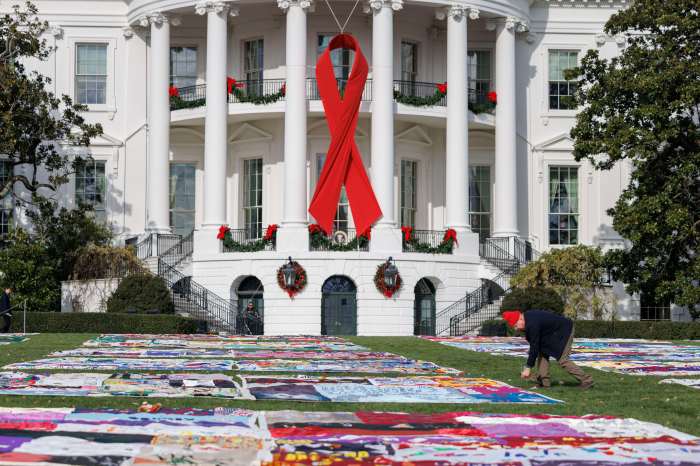 Crews work on the AIDS Memorial Quilt during an event to commemorate World AIDS Day on the South Lawn of the White House in Washington, DC, USA, on Sunday, December 1, 2024.