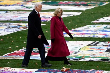 US President Joe Biden and First Lady Jill Biden walk past the AIDS Memorial Quilt on display for the first time on the South Lawn of the White House during an event marking World AIDS Day in Washington, December 1, 2024.