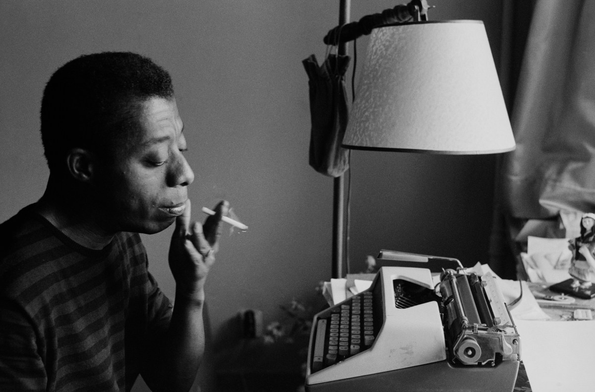 James Baldwin works on his novel, "Tell Me How Long the Train’s Been Gone," in 1965.