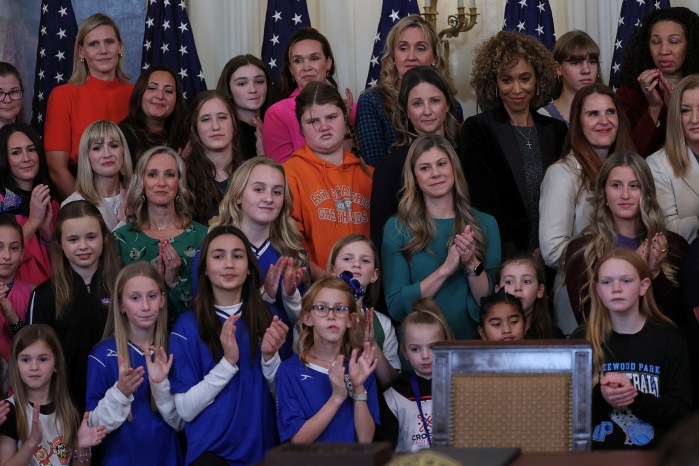 Attendees look on before President Donald Trump signs an executive order barring trans athletes from participating in sports.