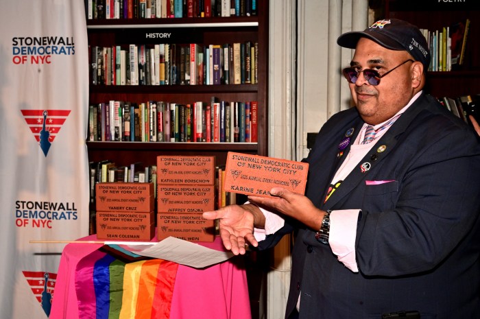 Stonewall Democratic Club of NYC vice president Kenny Agosto holds a brick-style award for former White House Press Secretary Karine Jean-Pierre, who was unable to attend.