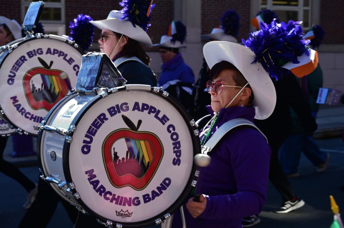 The Queer Big Apple Corps. Marching Band marches along.